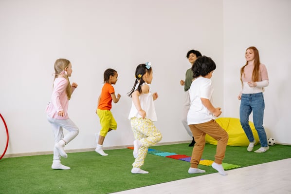 Children exercising in preschool classroom