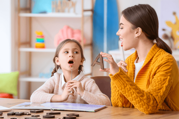 Child engaging in early intervention services with speech therapist